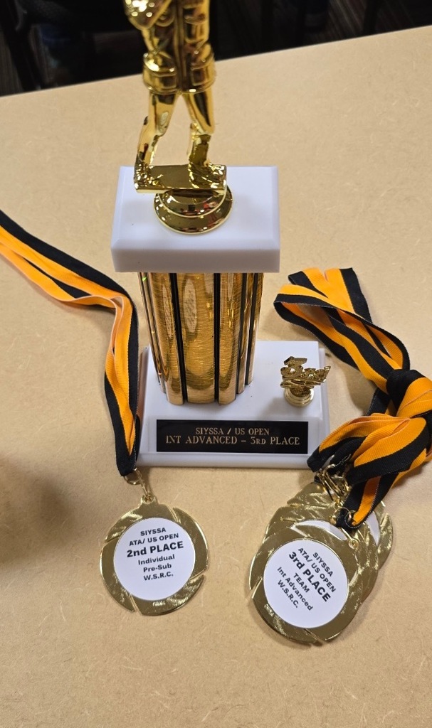 trophy and medals on a table