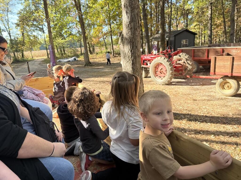 kindergarten students in a wagon at a pumpkin patch