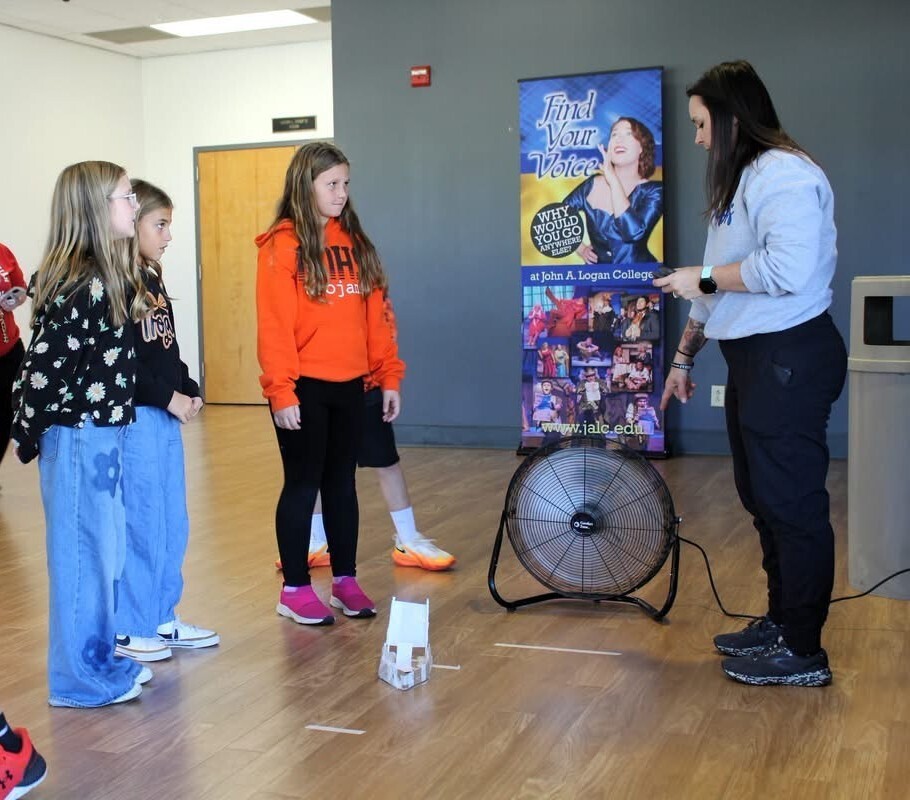 5th grade students testing a boat they built out of paper