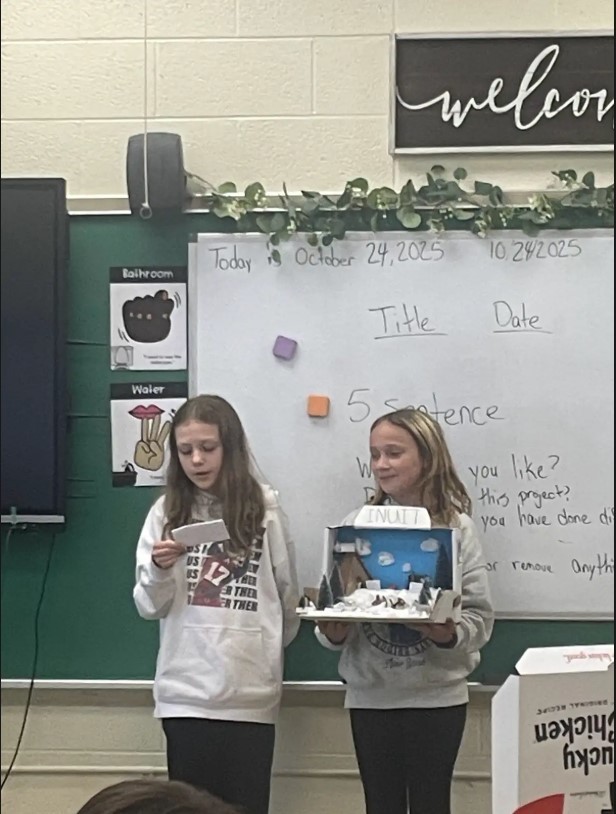 Two girls presenting project