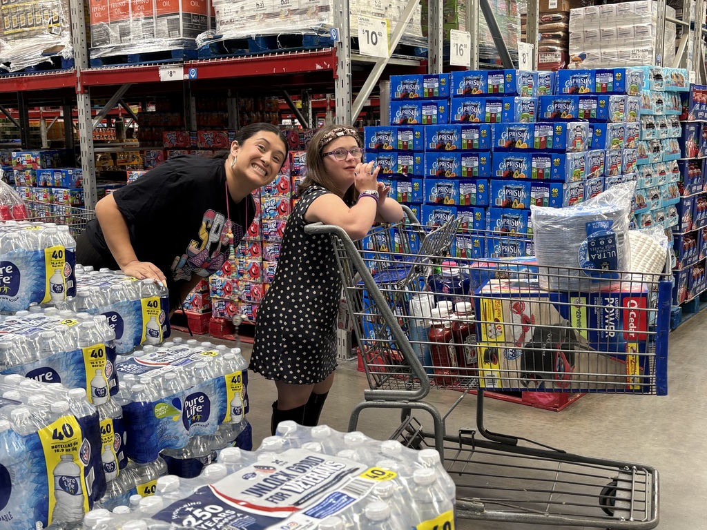 Aide and lifeskills student with cart of items