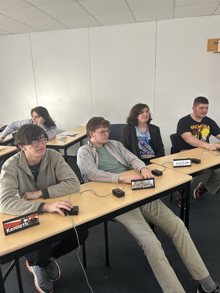 four students in the middle of a match