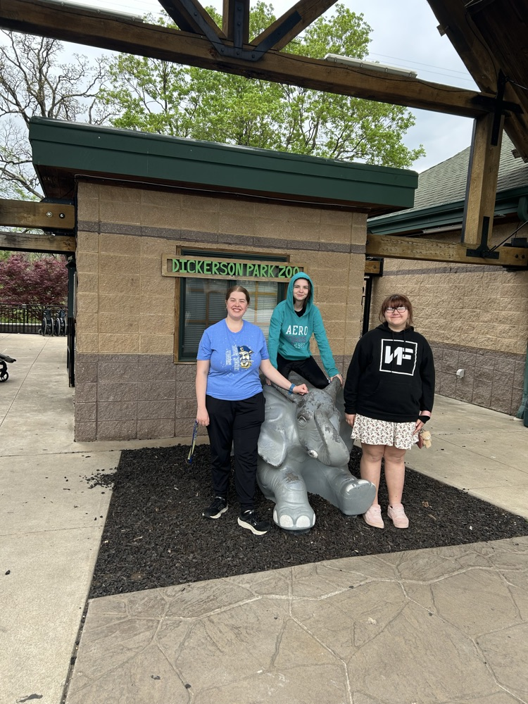 Mrs. Moore, Braley, and Justice in front of the zoo.