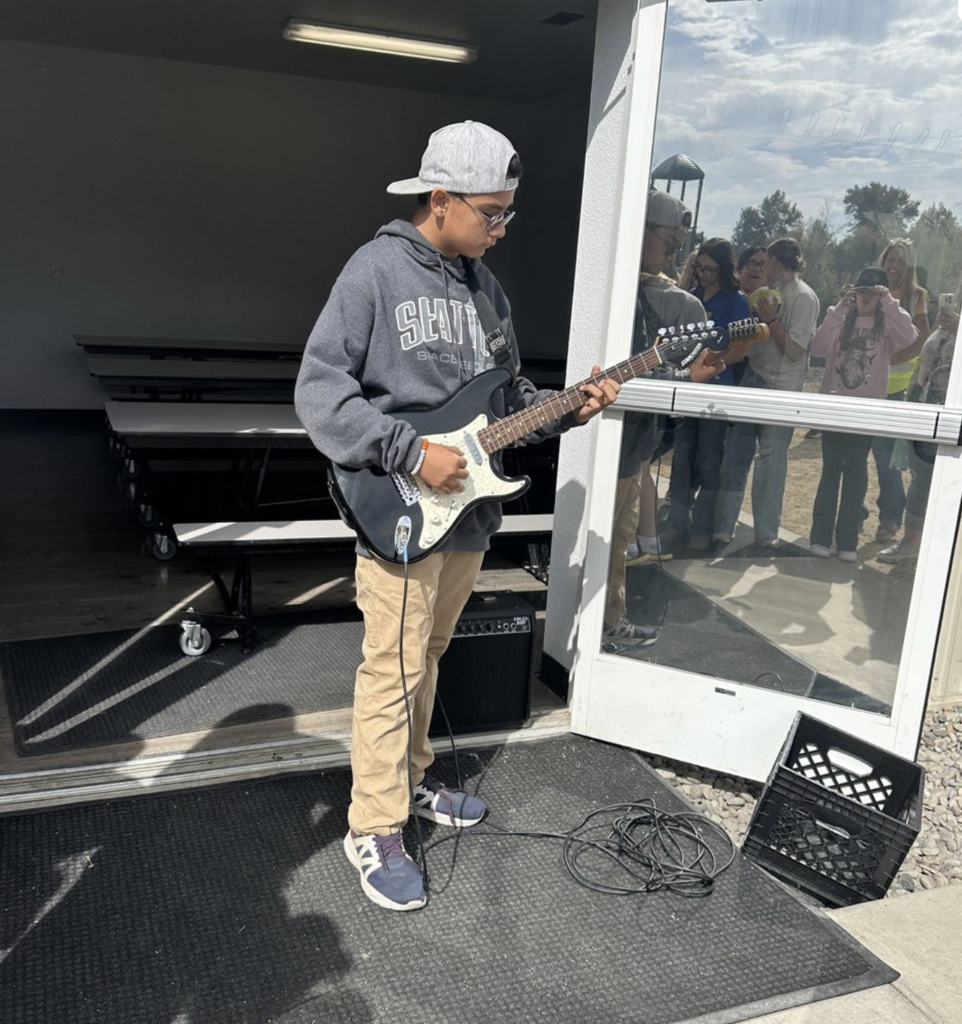 Scholar playing his guitar