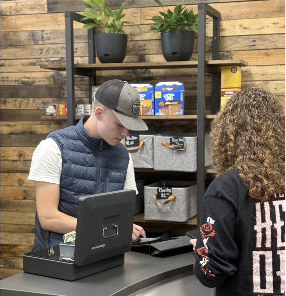 CLA scholar working at the student store
