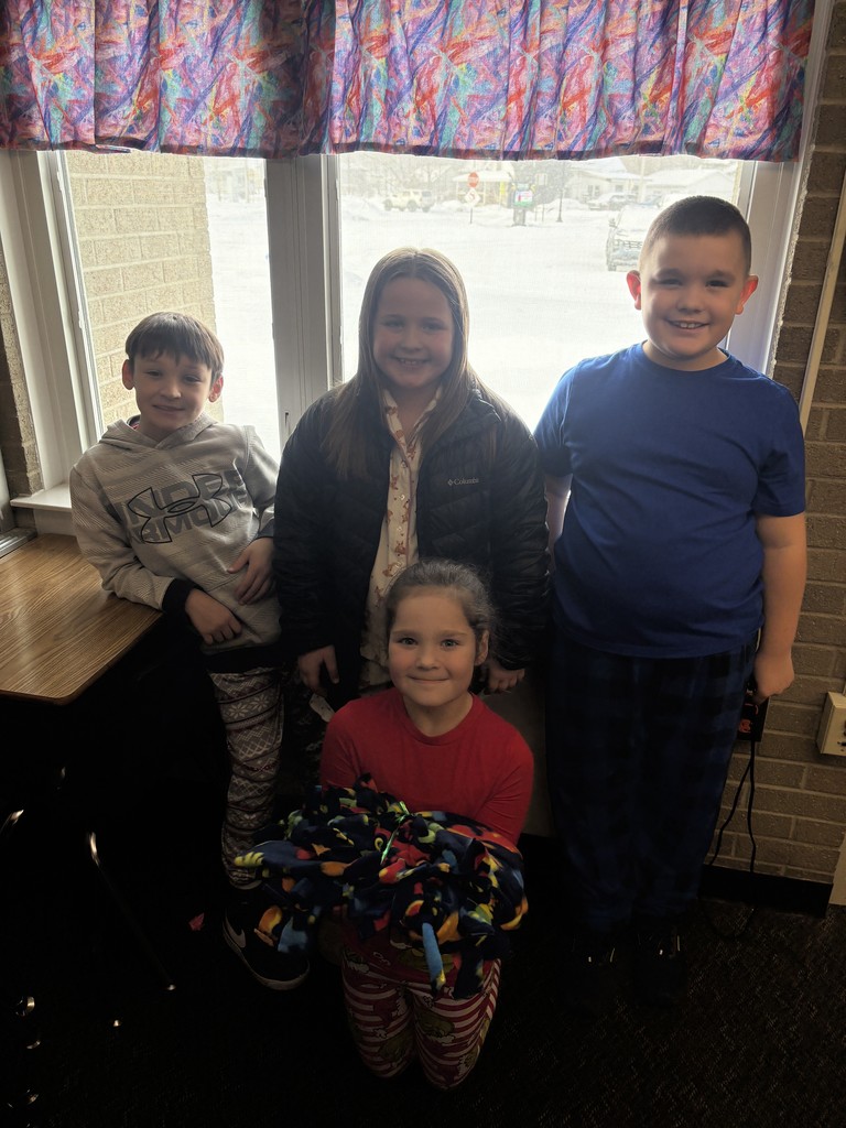 3rd grade students making tie blankets for their "giving celebration" 