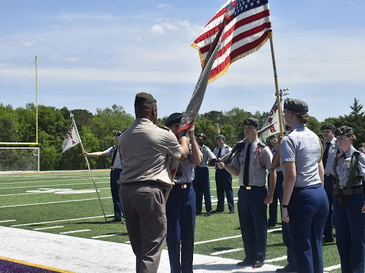 jrotc student stand ready during promotion ceremony