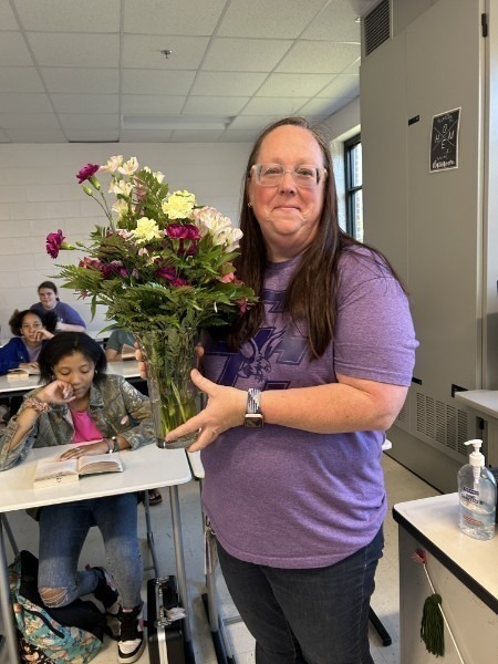  Support Staff Standing in Purple Shirt with Flowers