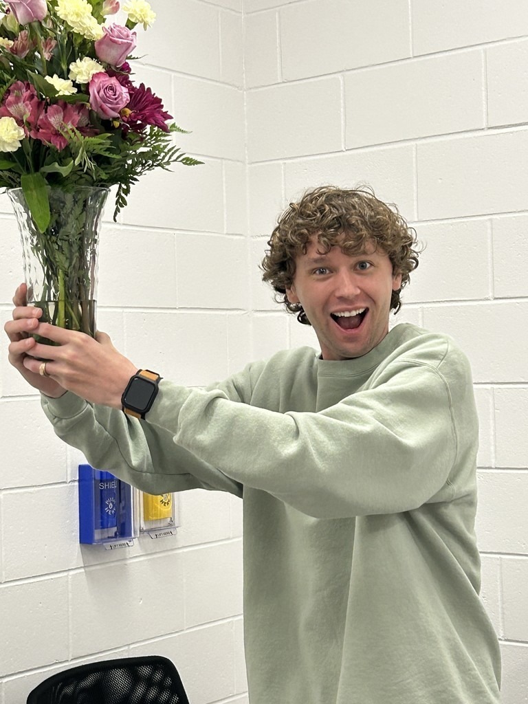 Teacher of the Year Standing with Flowers