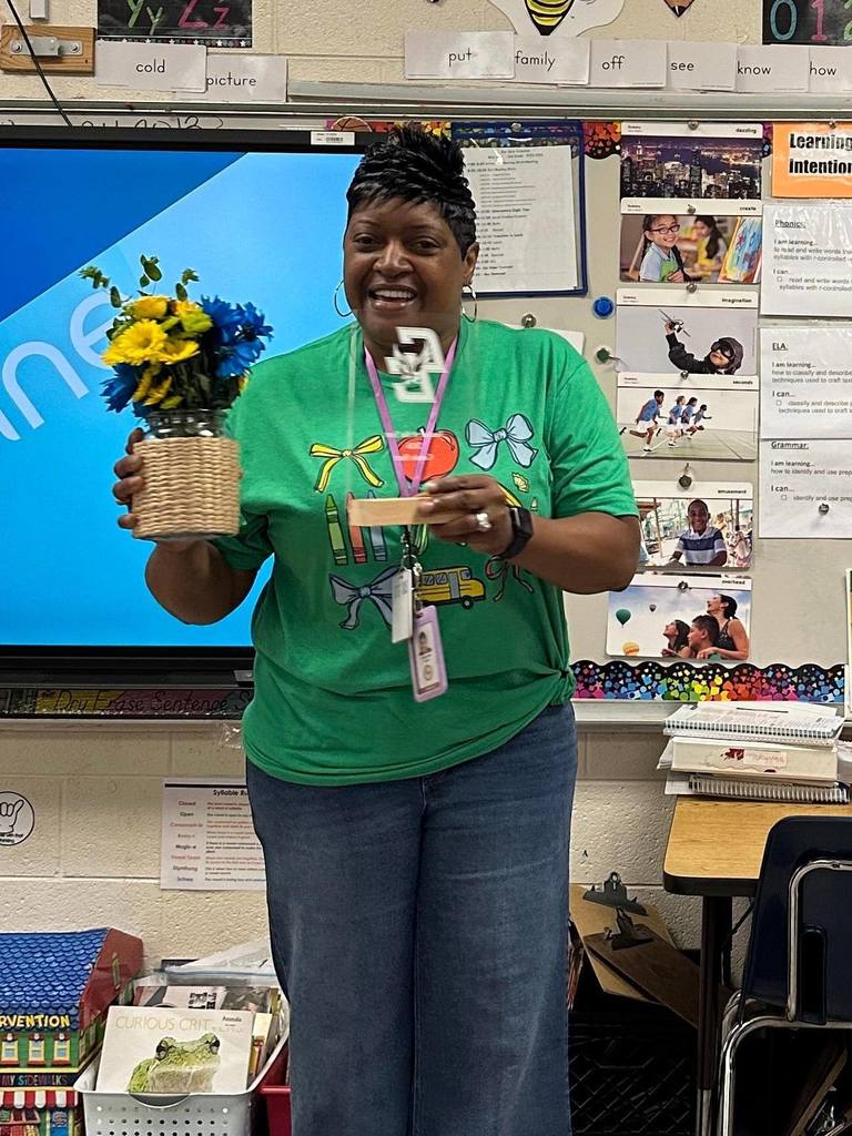 Teacher of the Year Standing with Flowers