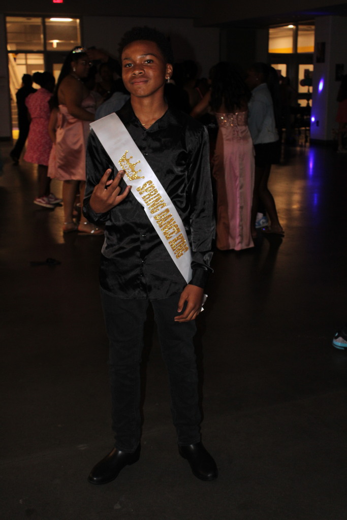 spring dance king poses for camera