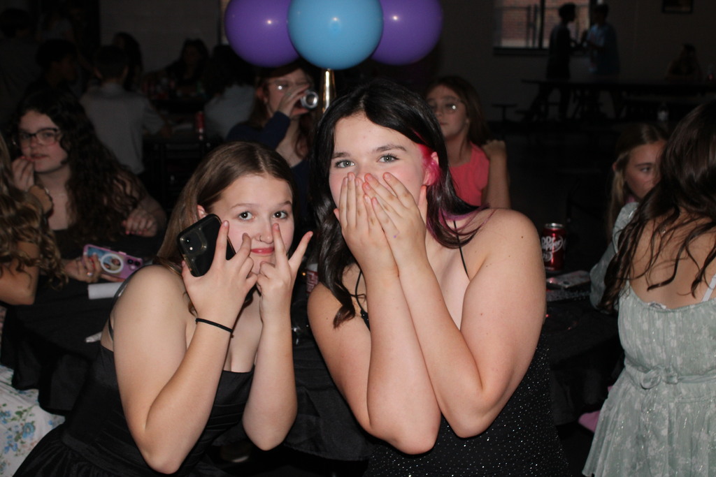 two girls posing for the camera at the spring dance