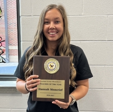hannah moncrief posing with her plaque