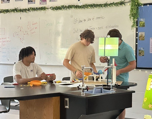 three students working on the group project