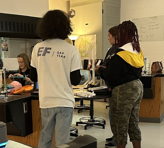 three students working on the group project