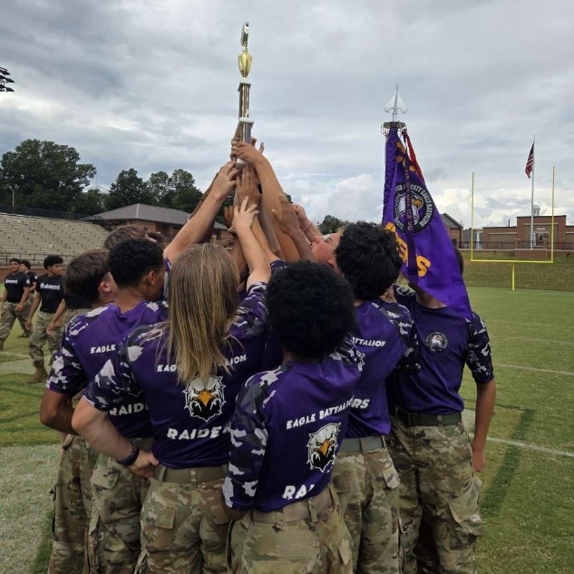 jrotc raiders team holding their trophy
