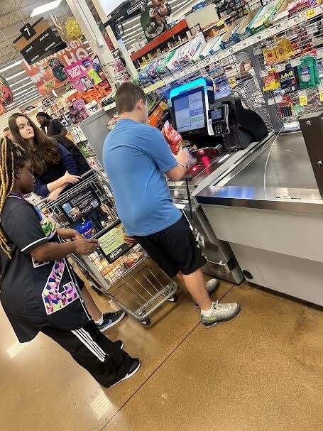 students scanning items at Kroger