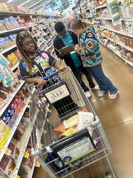 students shopping down the aisle at Kroger