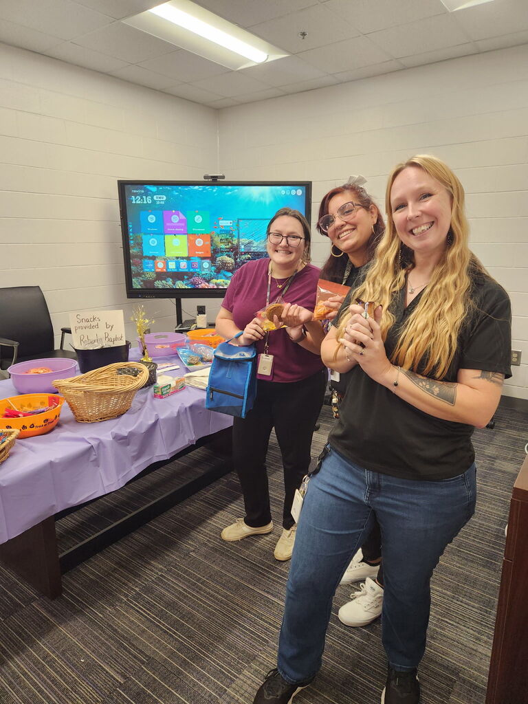 teachers smiling with donated snacks
