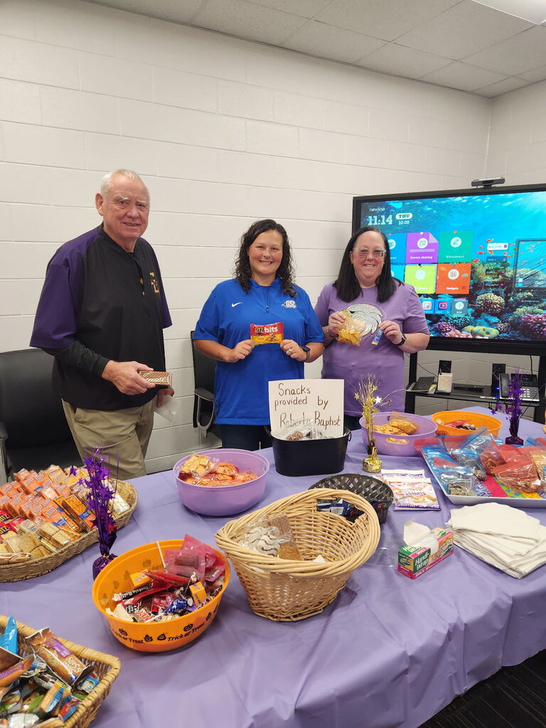 teachers smiling with donated snacks