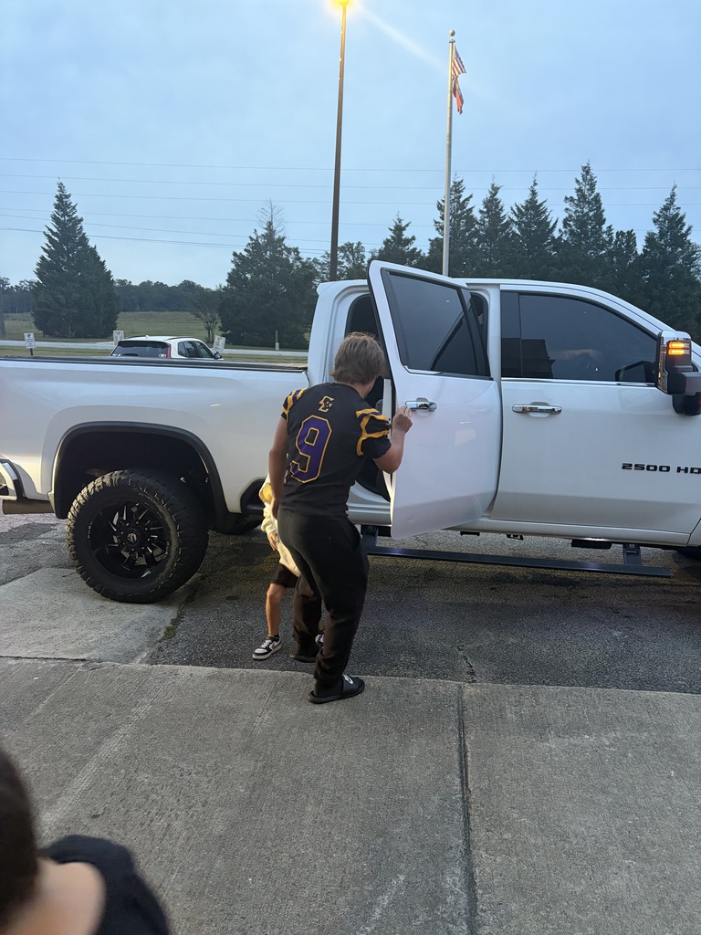 football player greeting a student