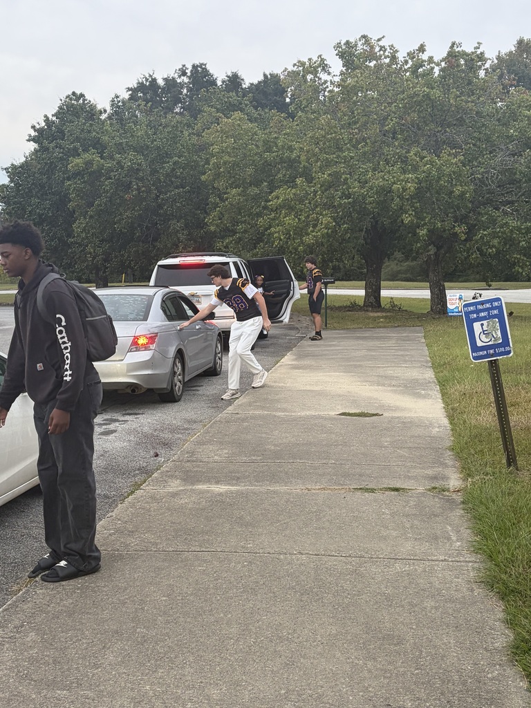 football players greeting students