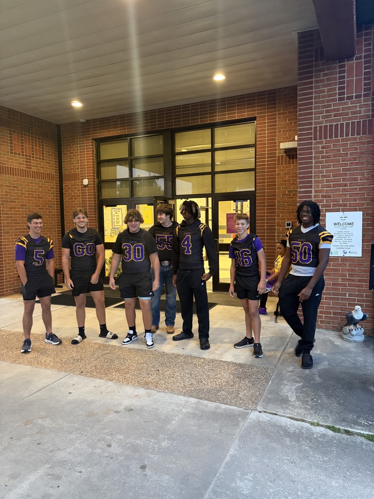 football players standing at the entrance of the elementary school