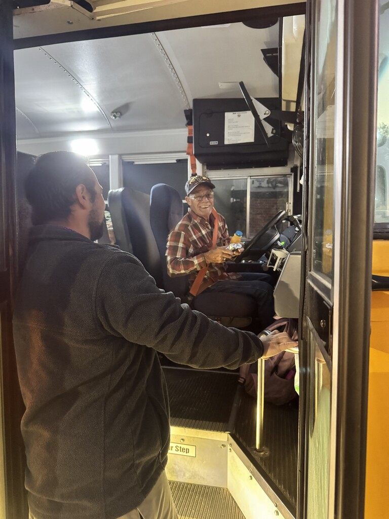 Teacher greeting a bus driver