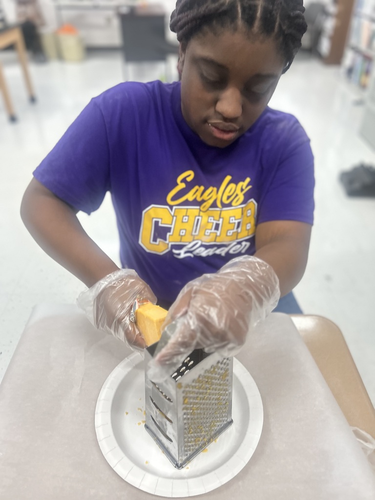 student grating cheese