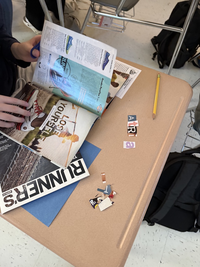 student working on their collage in class