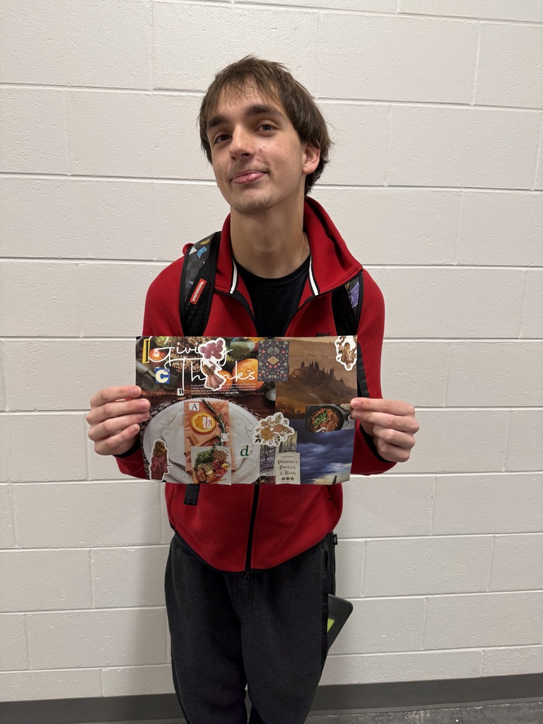 student holding up his collage