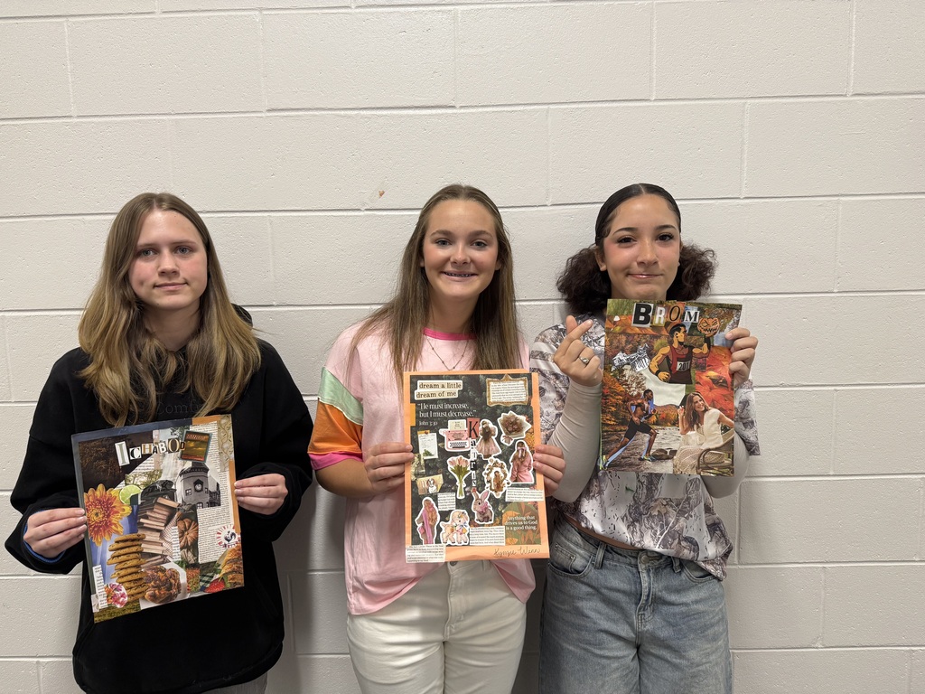 students holding up their collages