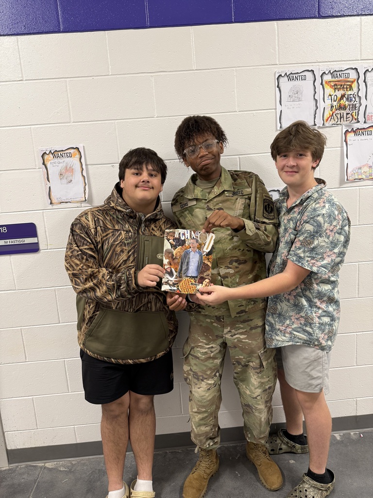 students holding up their collage