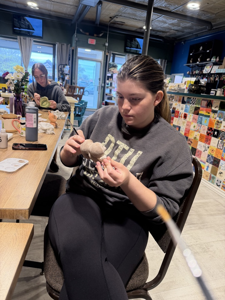 student working on pottery 