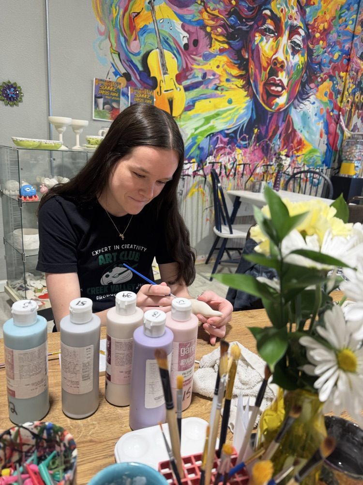 student working on pottery 