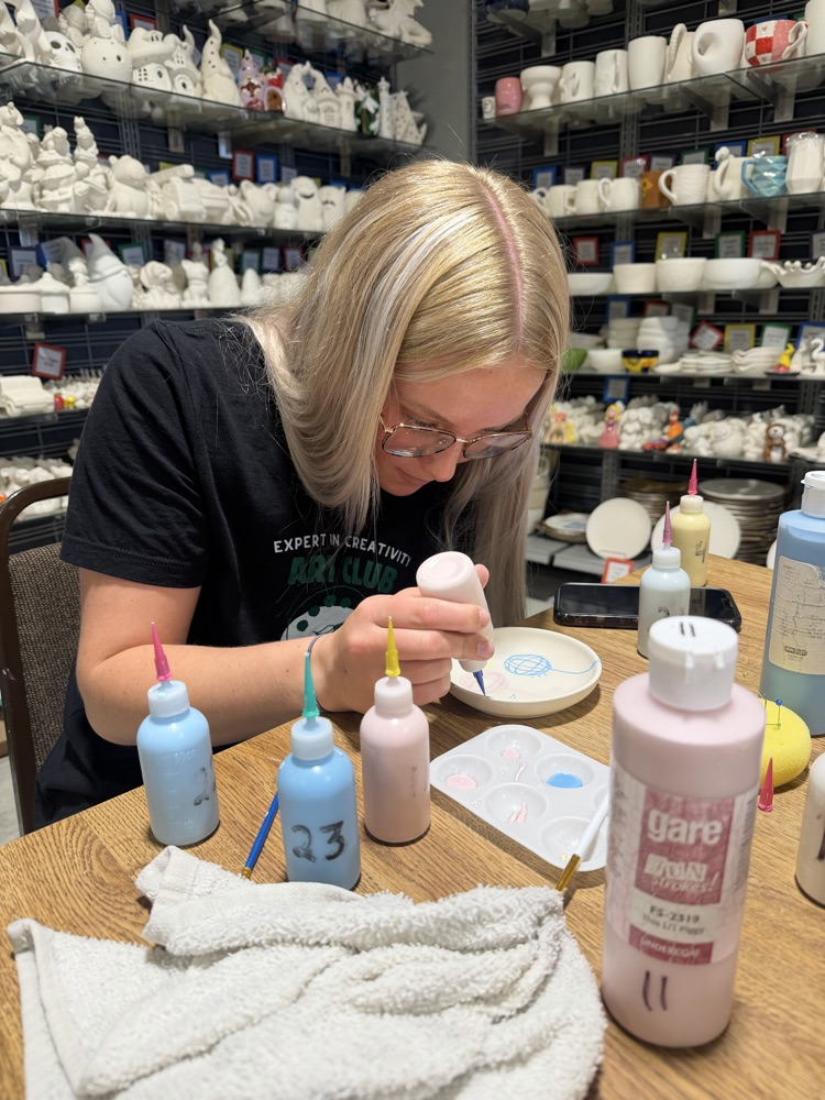 student working on pottery 
