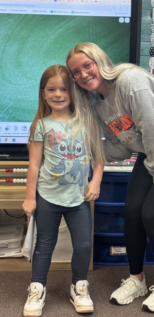 Big smiles from our seniors and second graders showing off their final piece of writing.