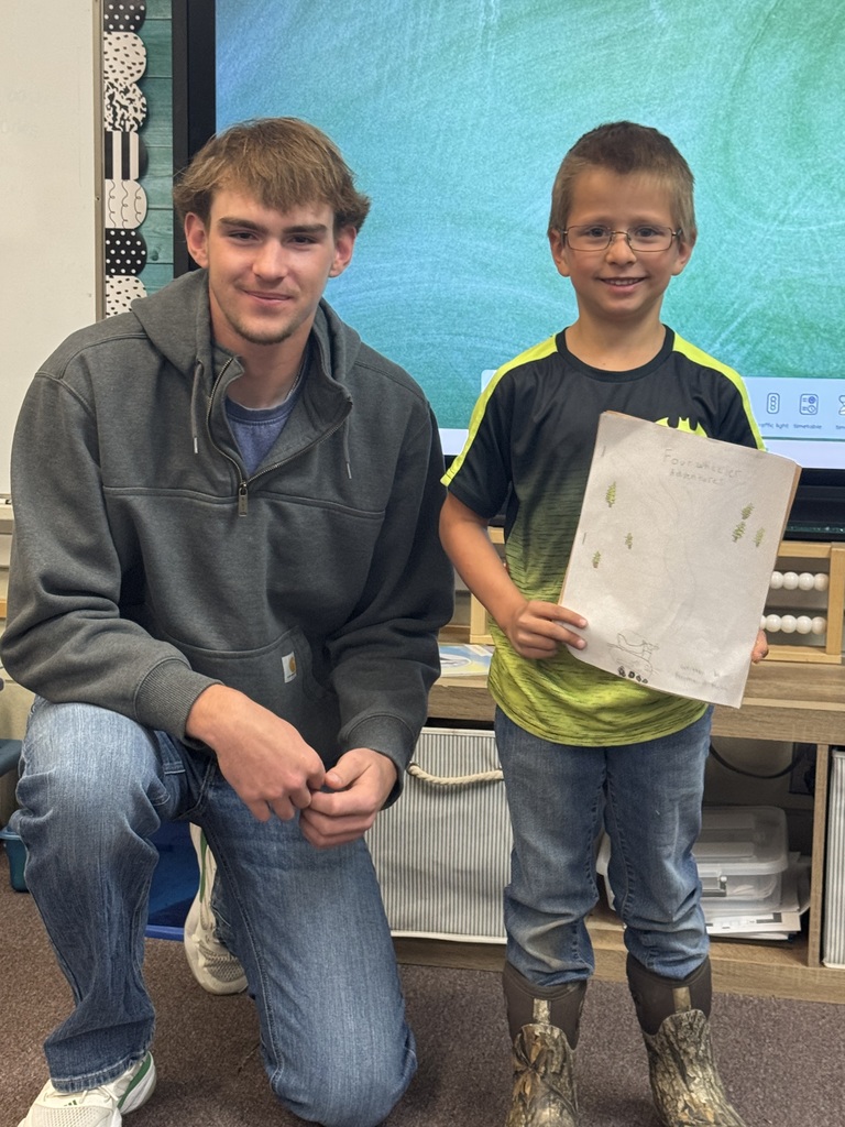 Big smiles from our seniors and second graders showing off their final piece of writing.