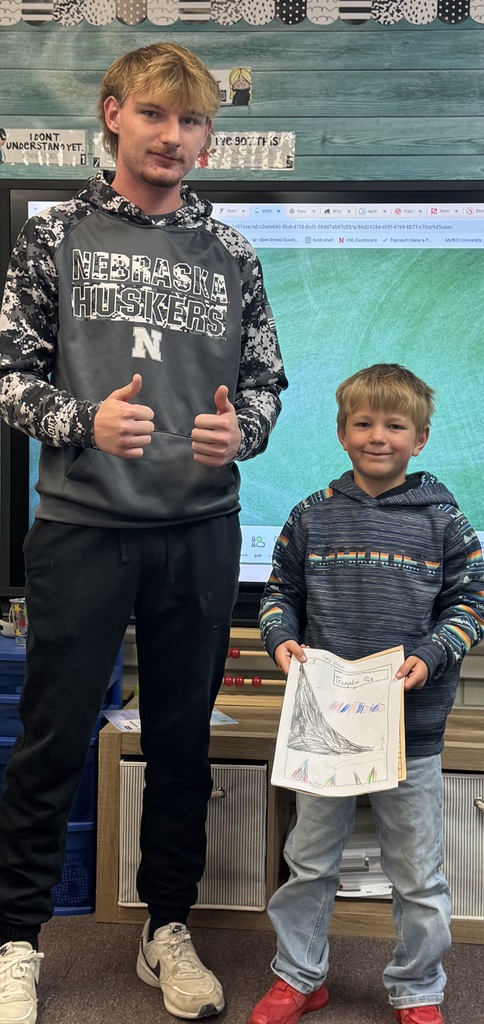 Big smiles from our seniors and second graders showing off their final piece of writing.