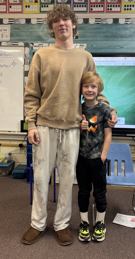 Big smiles from our seniors and second graders showing off their final piece of writing.