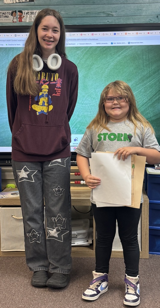 Big smiles from our seniors and second graders showing off their final piece of writing.