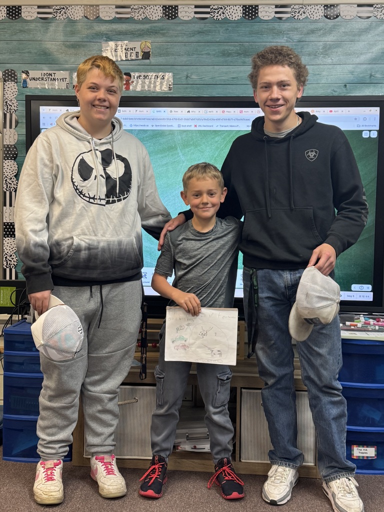 Big smiles from our seniors and second graders showing off their final piece of writing.