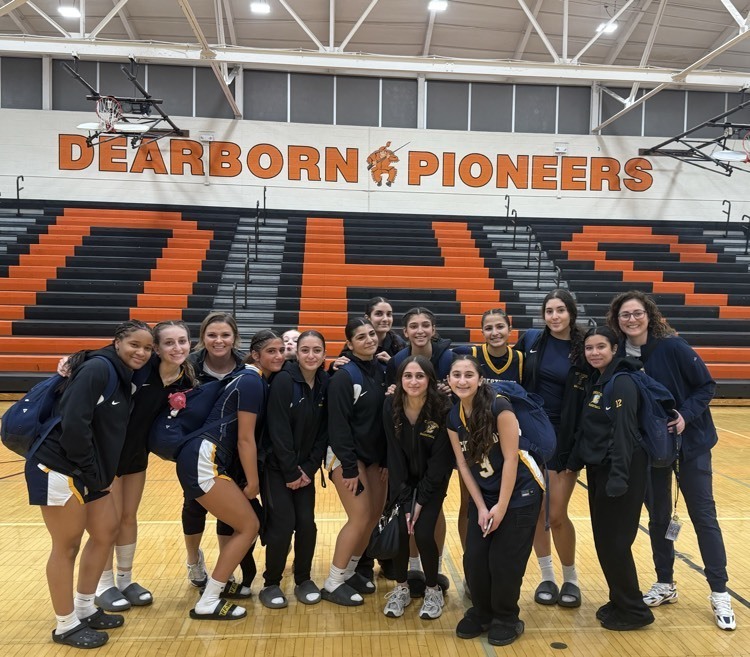 Girls Varsity Basketball team poses after their big Win vs Dearborn HS