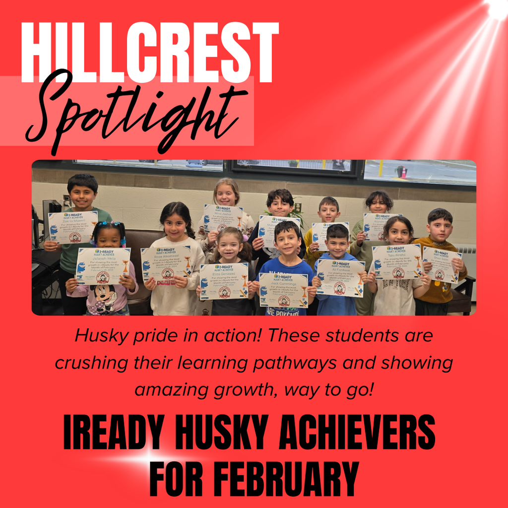 A red graphic titled “Hillcrest Spotlight” featuring a group of elementary students standing in a classroom and proudly holding certificates. The children are smiling and standing in two rows in front of large windows, each holding an “i-Ready Husky Achiever” award.  Text on the graphic celebrates the students’ progress, noting that they are “crushing their learning pathways and showing amazing growth.” The bottom headline reads “iReady Husky Achievers for February,” recognizing their hard work and academic achievements.