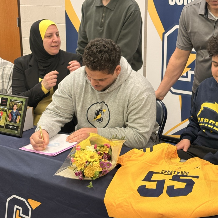 Hussein Ajrouche signs his letter of intent to play football at Adrian College