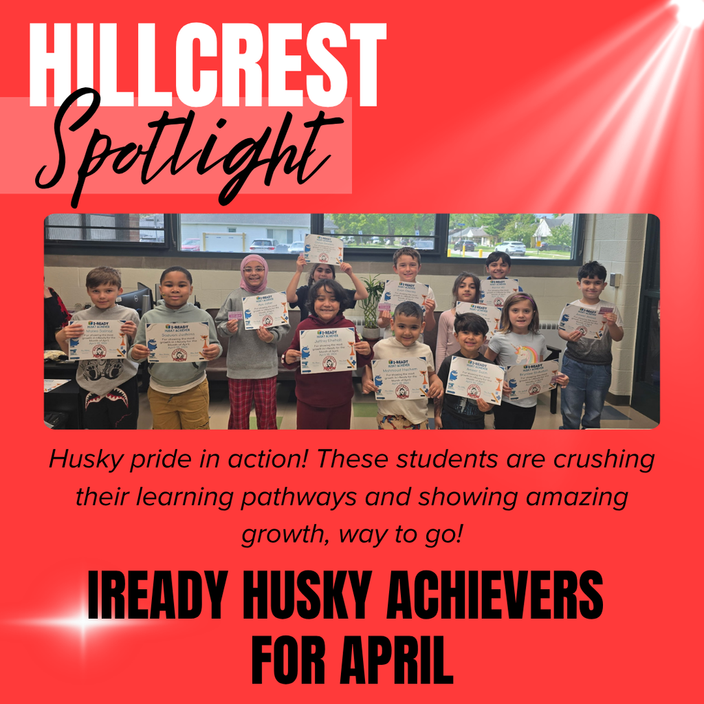A bright red school recognition graphic titled “HILLCREST Spotlight” appears at the top left. The word “HILLCREST” is written in very large white block letters, while the word “Spotlight” appears underneath in large black cursive lettering over a lighter red rectangular background. White spotlight beams shine diagonally from the upper right corner across the red background, and a glowing white sparkle effect appears near the bottom left corner.  Centered on the graphic is a large group photograph of elementary school students standing indoors and proudly holding achievement certificates. The students are arranged in rows and smiling toward the camera. The certificates display the title “i-READY HUSKY ACHIEVERS” along with student names and achievement information. Large classroom windows behind the students show trees, houses, and parked cars outside.  Below the photo is black italicized text that reads: “Husky pride in action! These students are crushing their learning pathways and showing amazing growth, way to go!”  At the bottom of the graphic, very large bold black block letters read: “IREADY HUSKY ACHIEVERS FOR APRIL.” The overall design uses a celebratory school spotlight theme with bold red coloring, dramatic white light beams, and student achievement recognition imagery.