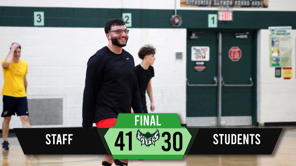 People playing basketball indoors. Scores on a digital display read 41 to 30.
