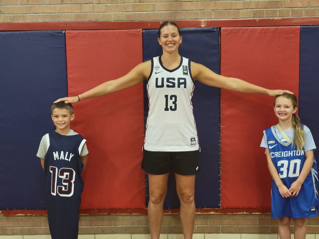 Basketball player with two younger students.