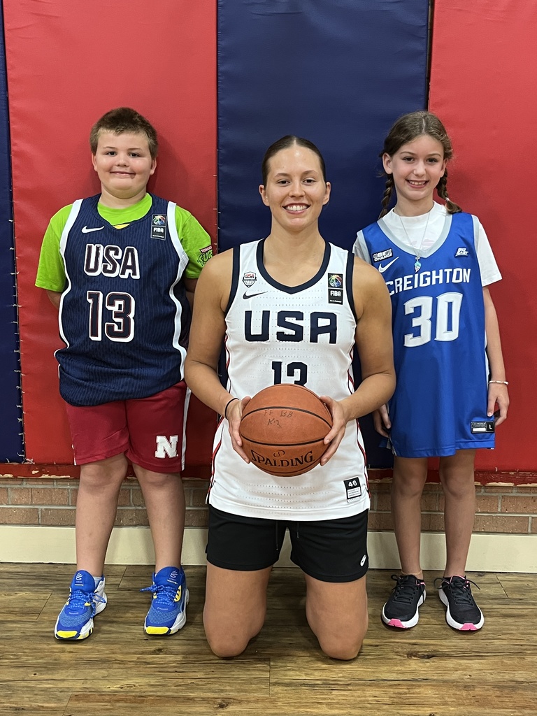 Basketball player with two younger students.
