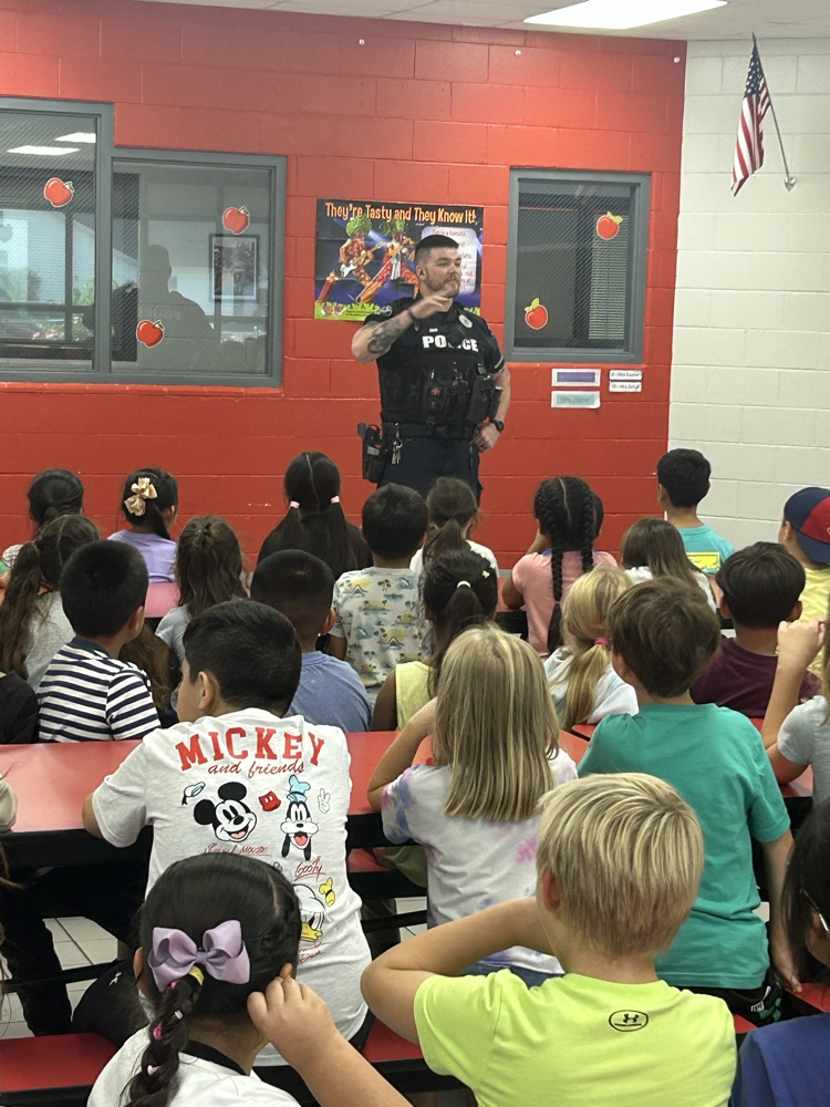 Officer Zach talks to students  